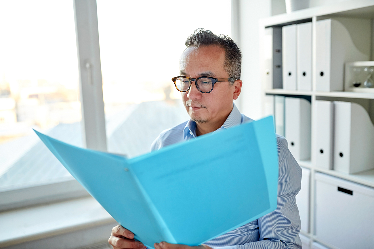 business man looking at bookkeeping record